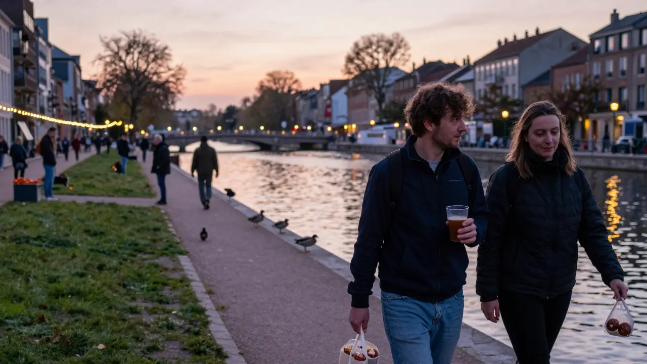 A couple walking along Canal Saint-Martin with reusable cups, surrounded by locals playing pétanque at dusk.