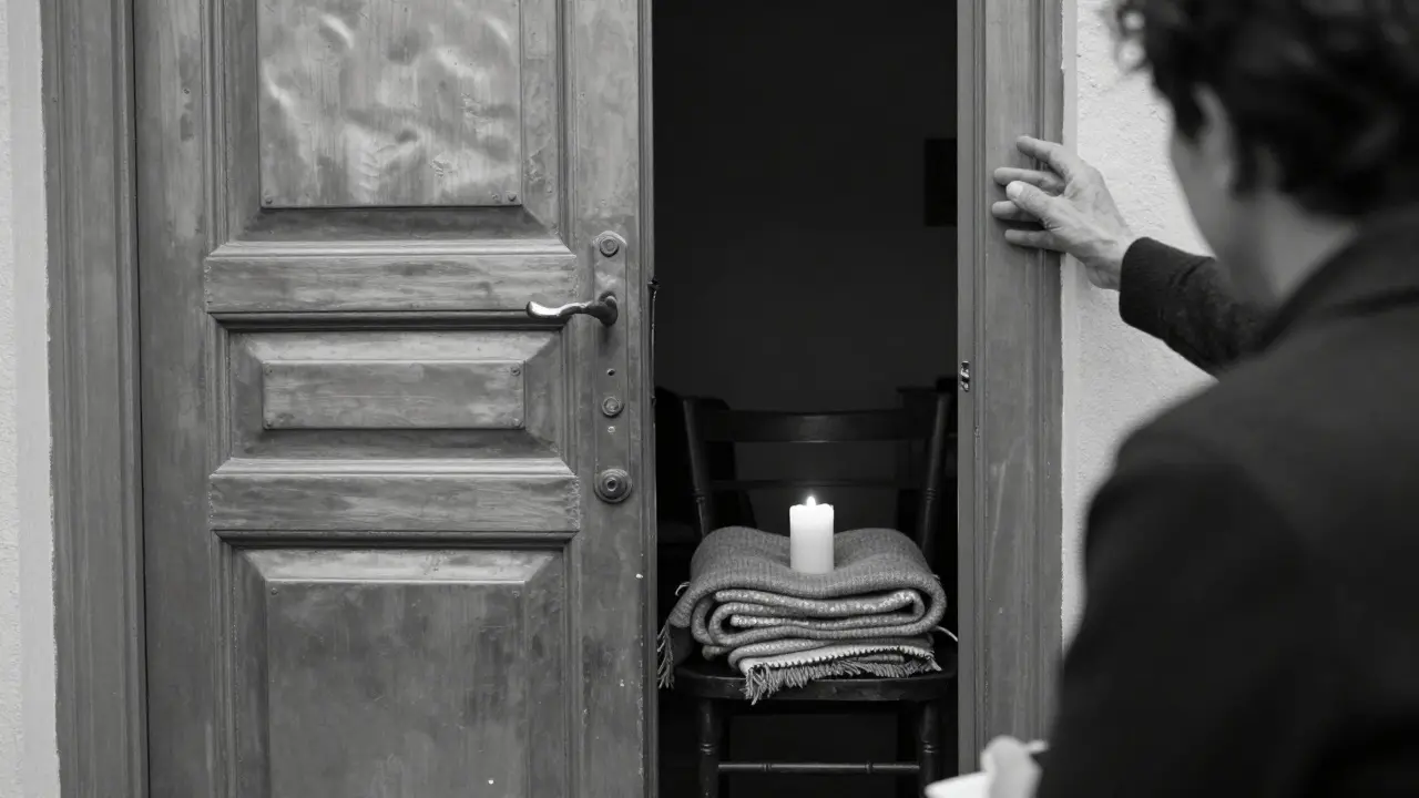 A minimalist massage room with a single candle and wool blanket, capturing quiet trust between therapist and client.